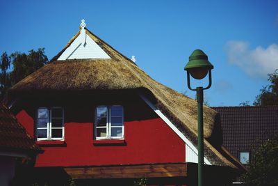 Low angle view of house against blue sky