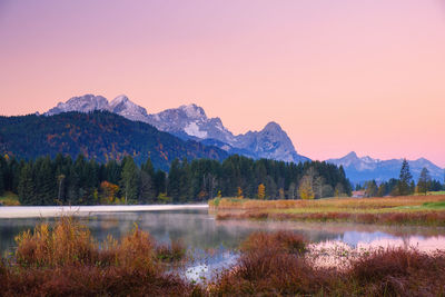 Scenic view of lake and mountains against clear sky