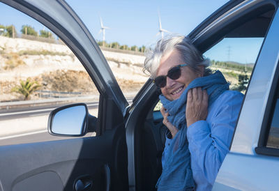 Portrait of smiling woman sitting in car