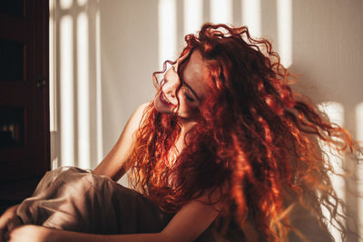 Portrait of smiling young woman at home