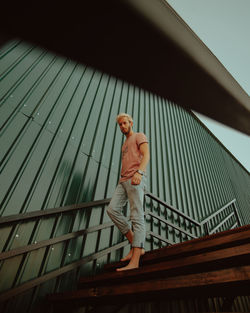 Low angle view of person standing on railing