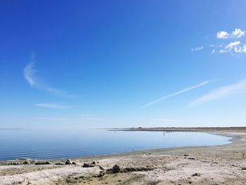 Scenic view of a dead sea against blue sky