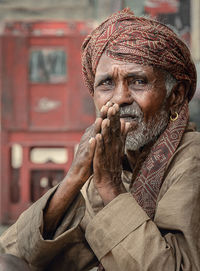 Portrait of mature man with hands clasped