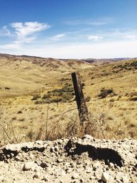 Scenic view of field against cloudy sky