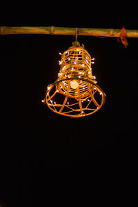 Low angle view of illuminated light bulbs in the dark