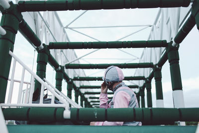 Full length of girl standing on footbridge