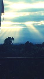 Scenic view of landscape against sky at sunset