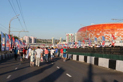 People on road against buildings in city