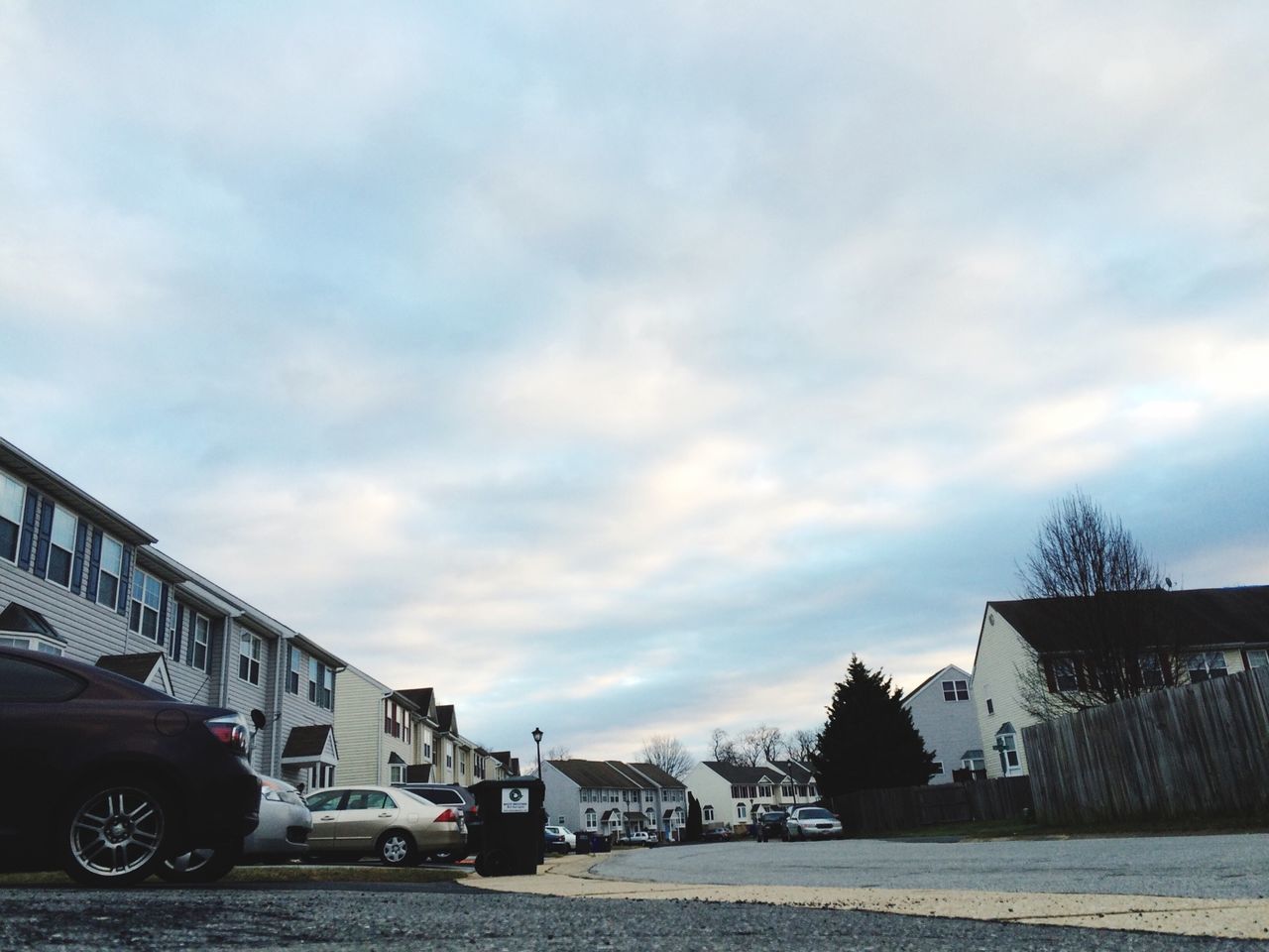 transportation, architecture, sky, building exterior, built structure, land vehicle, cloud - sky, mode of transport, car, road, street, cloudy, cloud, weather, outdoors, parking, day, city, stationary, parked