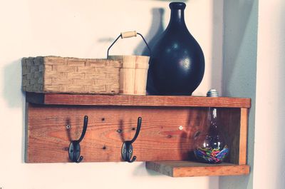 Close-up of centerpieces on wooden shelf at home