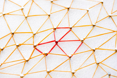 High angle view of design made with rubber bands and nails