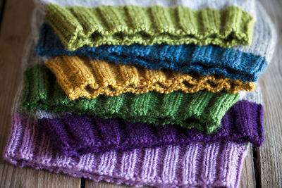 Close-up of multi colored knit hats on wooden table