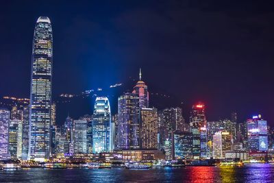 Illuminated buildings against sky at night