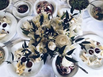 Directly above shot of vase and food on table during wedding