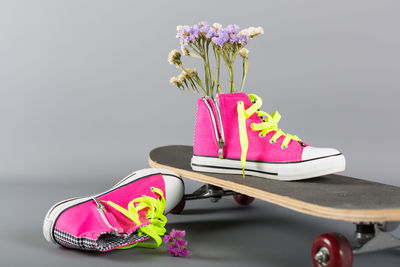 High angle view of pink shoes on floor against white background