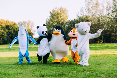 People wearing costume standing at park outdoors