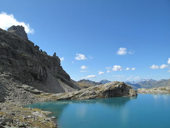 Scenic view of lake and mountains against sky