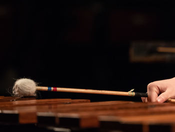 Close-up of hand playing piano