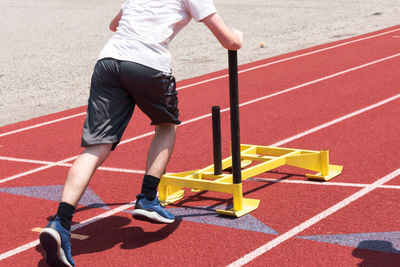 Low section of man running on road
