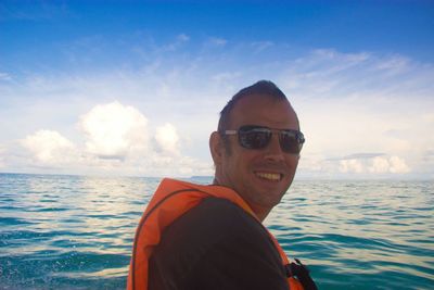 Portrait of smiling young man sailing in sea
