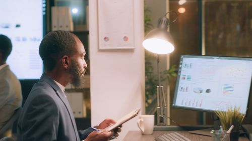 Side view of businessman using laptop at office