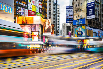 Blurred motion of train on road in city