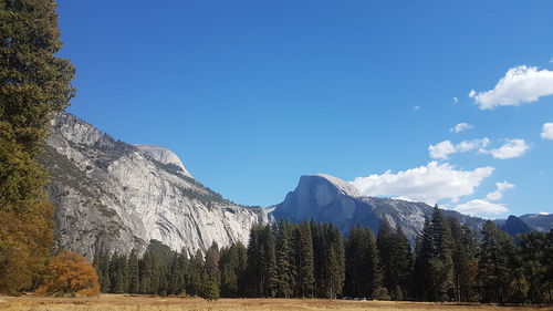 Panoramic view of snowcapped mountains against blue sky