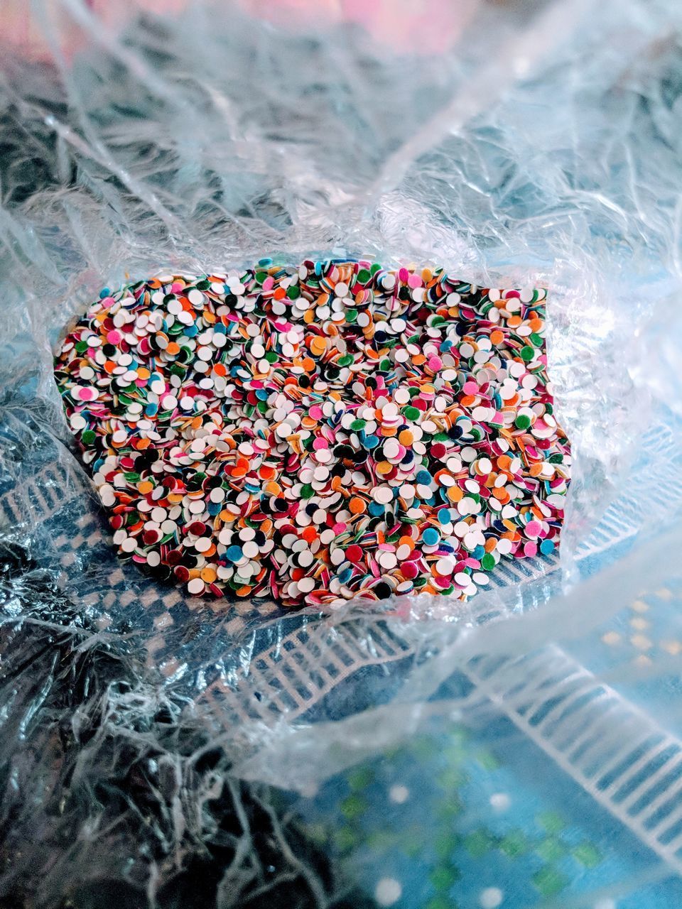 HIGH ANGLE VIEW OF MULTI COLORED CANDIES IN GLASS