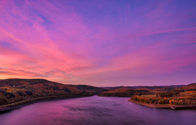 Scenic view of lake against romantic sky at sunrise 