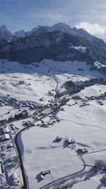 Aerial view of snow covered mountains against sky