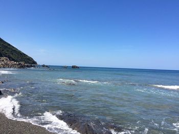 Scenic view of sea against clear blue sky