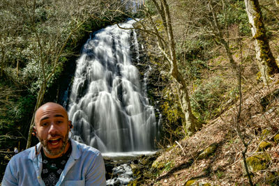 Hiker posing with crabtree falls near little switzerland nc