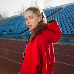 Portrait of woman standing on stadium