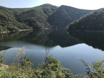 Scenic view of lake and mountains against sky