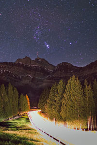 Scenic view of mountains against sky at night