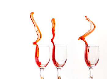 Close-up of red wine against white background