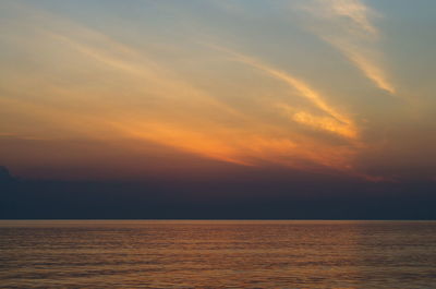 Scenic view of sea against romantic sky at sunset