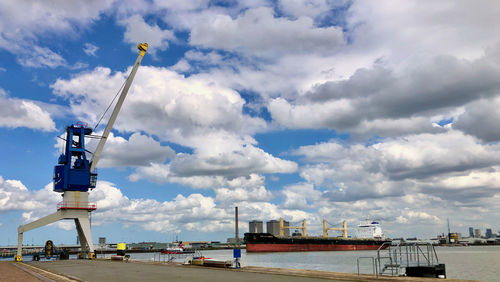 Commercial dock by sea against sky