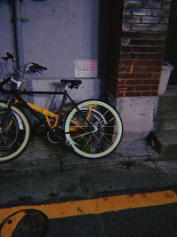 Bicycle parked on wall by building