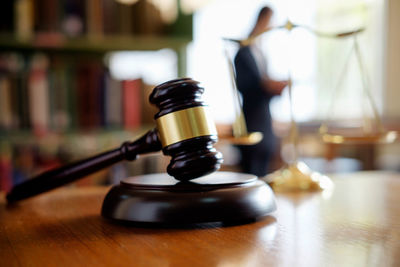 Close-up of gavel at desk in office