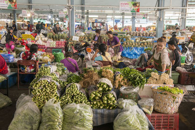 Group of people for sale at market stall