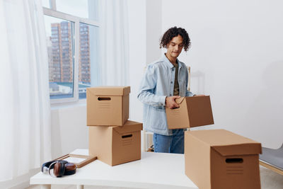 Portrait of young woman holding box