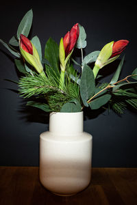 Close-up of white roses in vase on table