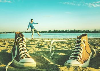 Man standing on beach against clear sky
