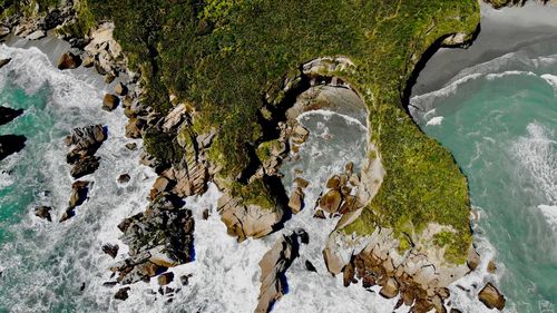 High angle view of stream flowing through rocks