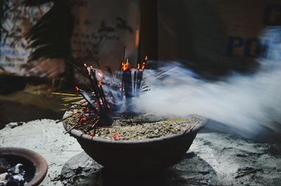 Close-up of burning candles in temple