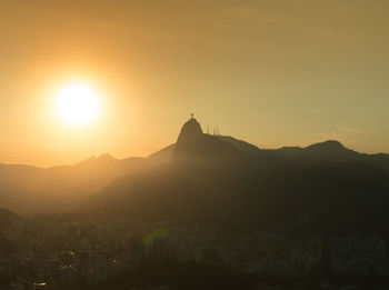 Silhouette of buildings against sky during sunset