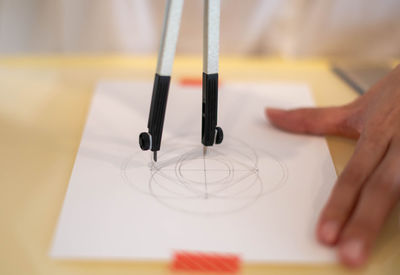 Cropped hand of person working on table