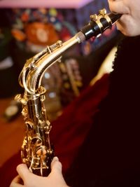 Midsection of man playing saxophone