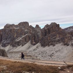 Person walking on road against dolomites